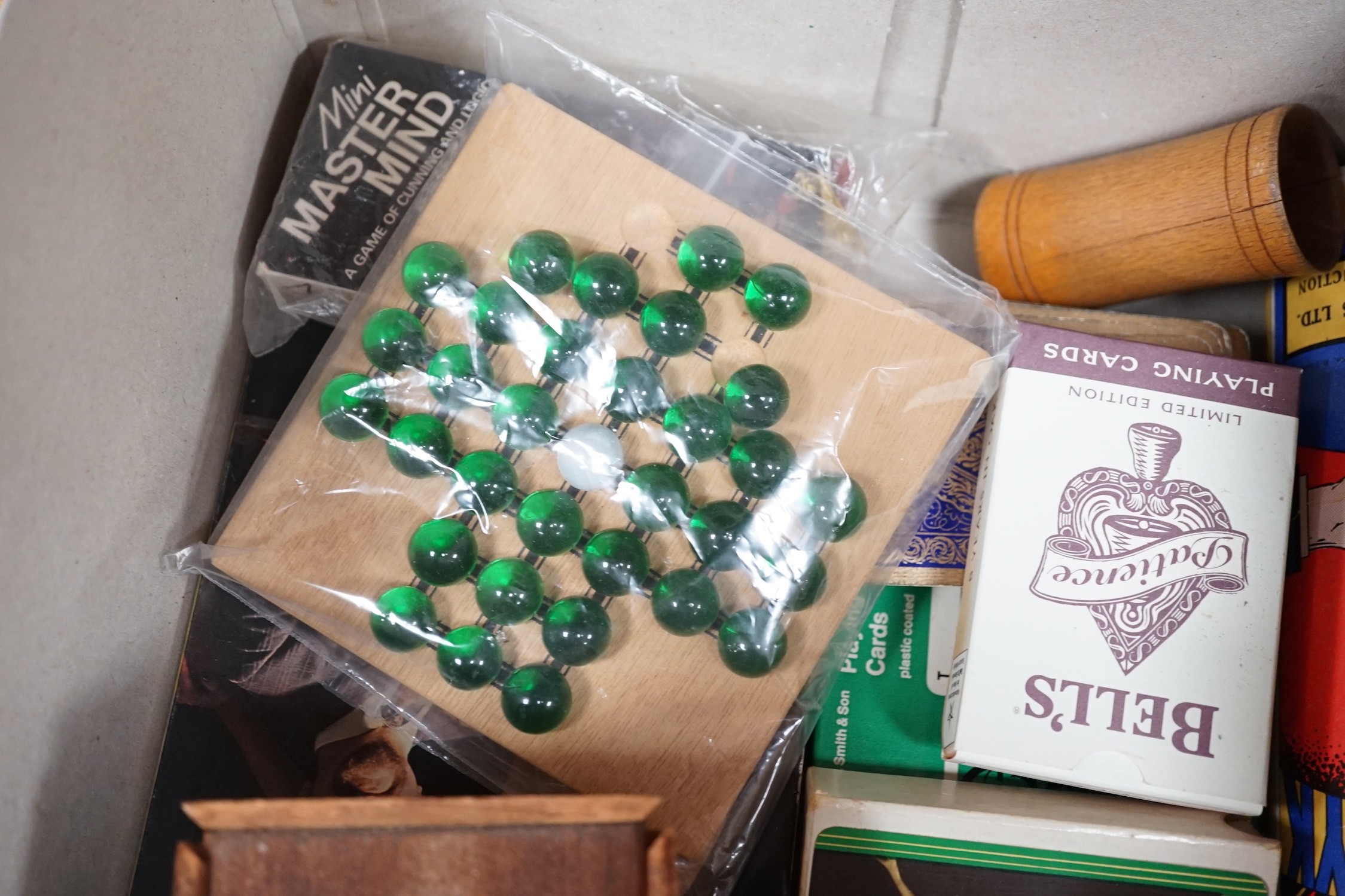 A selection of various games, to include a cribbage board, cards etc.